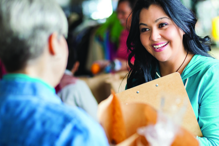 woman in blue shirt holding clipboard
