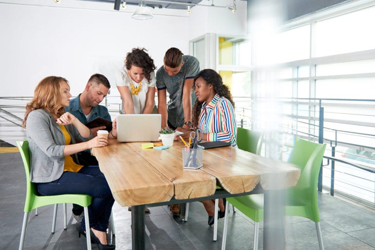 group of people working on a laptop