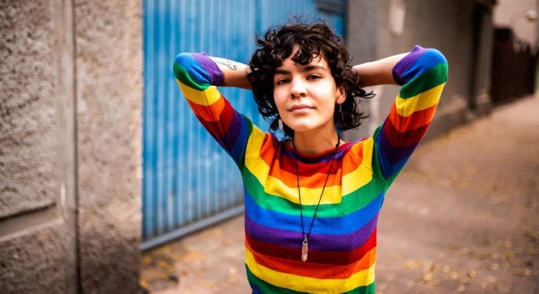 woman wearing rainbow colored sweatshirt