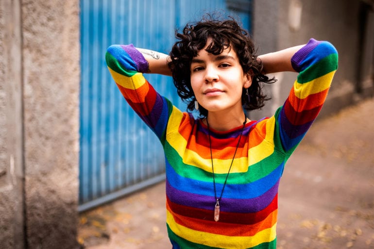 woman wearing rainbow colored sweatshirt