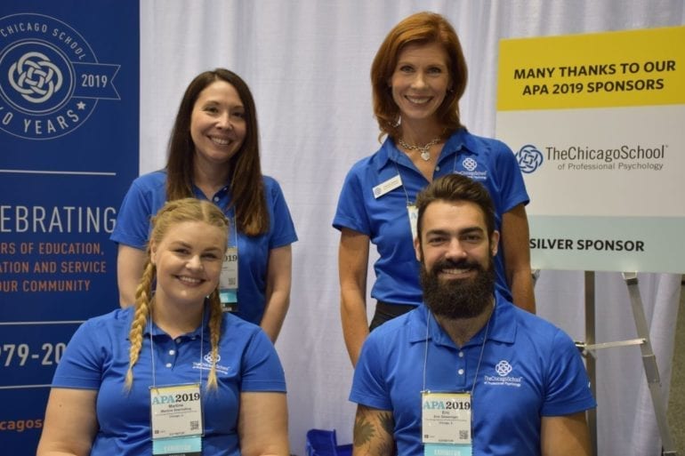 four people in blue shirts