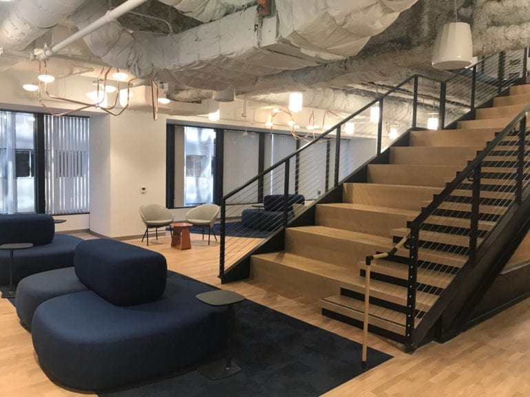 stairs leading to blue couches