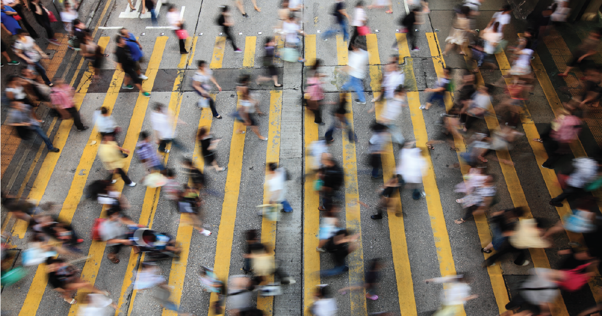 image of many people crossing a street