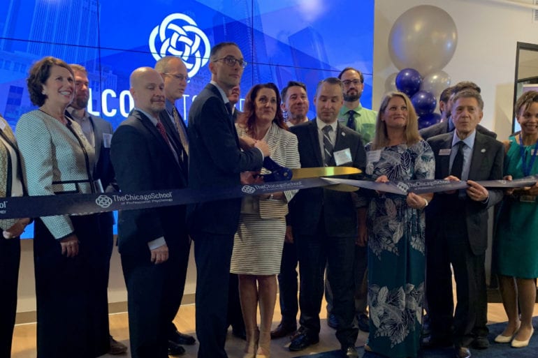 ribbon cutting ceremony with large scissors