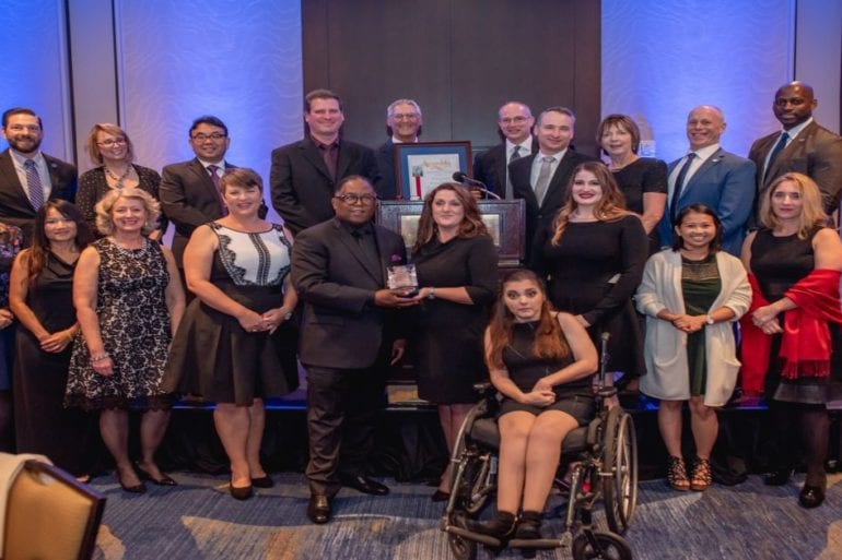 group of people receiving awards on stage