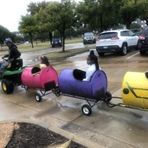 kids riding in colored barrels