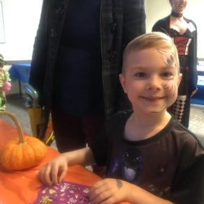 young boy with a ghost painted on his face