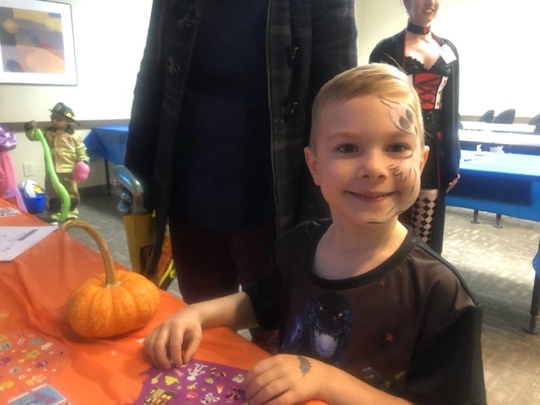 young boy with a ghost painted on his face