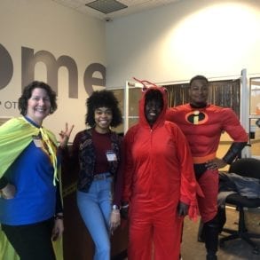 four people posing for the camera