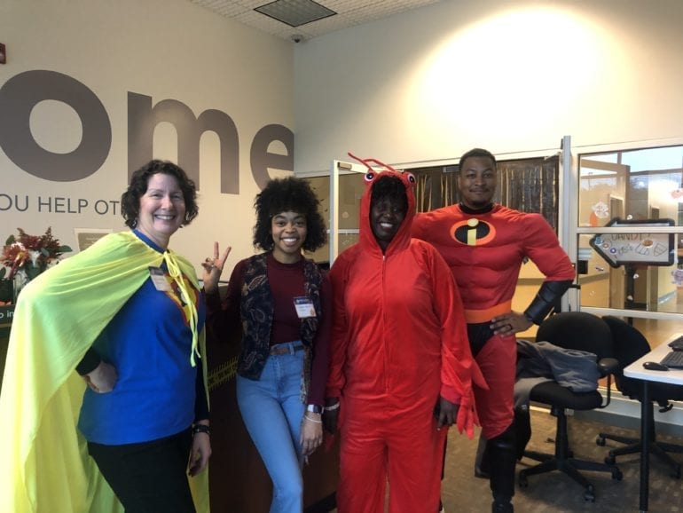 four people posing for the camera