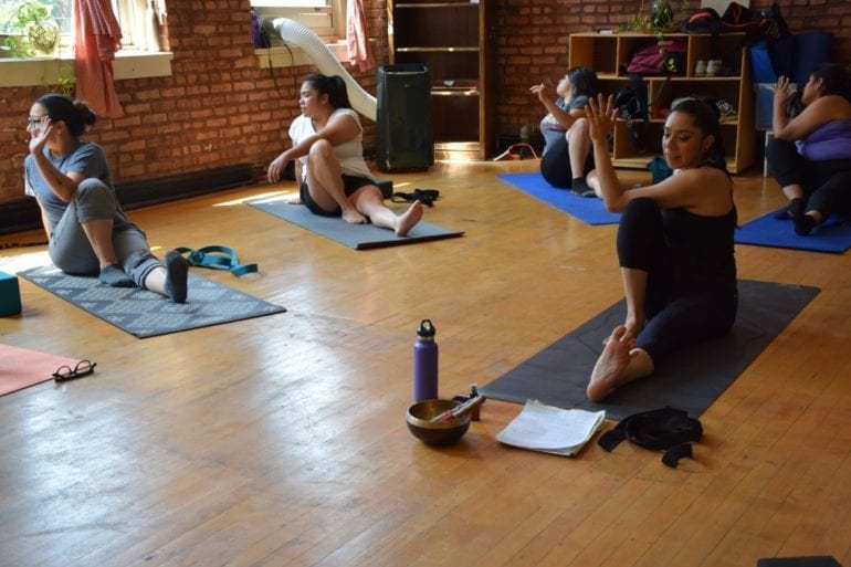 group of women stretching in yoga class