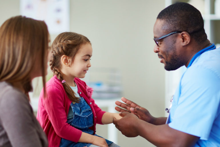 male nurse helping young girl