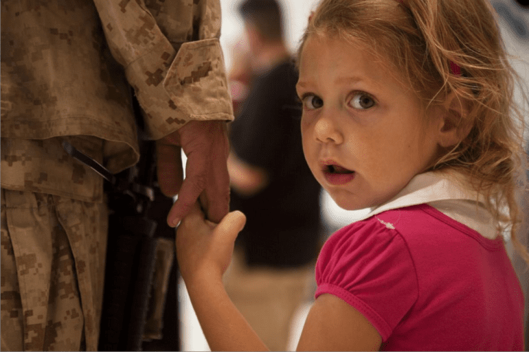 young girl holding dad's hand