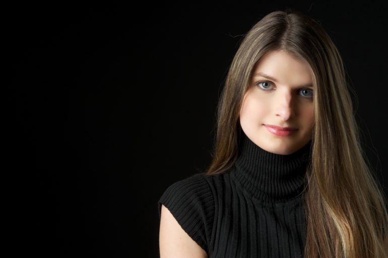 Alicia Kozak against a black background