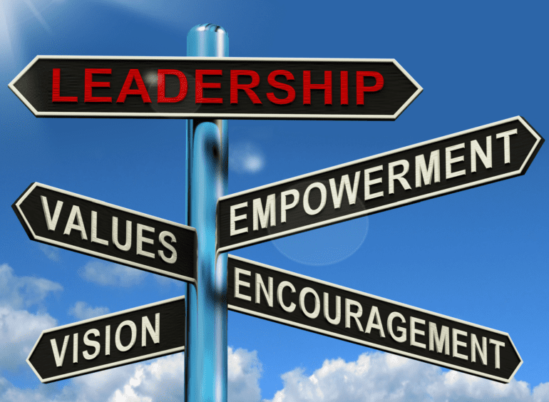 street sign with the word leadership in red