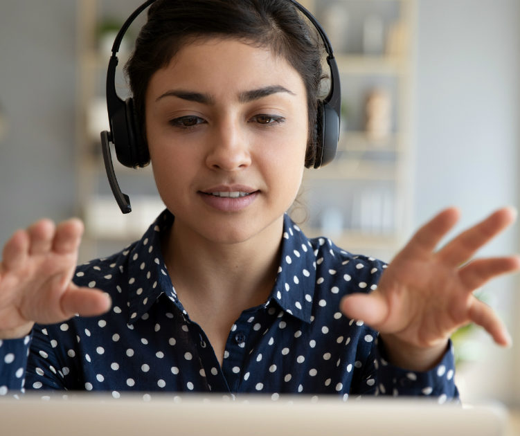 woman with headphones on computer, online counseling