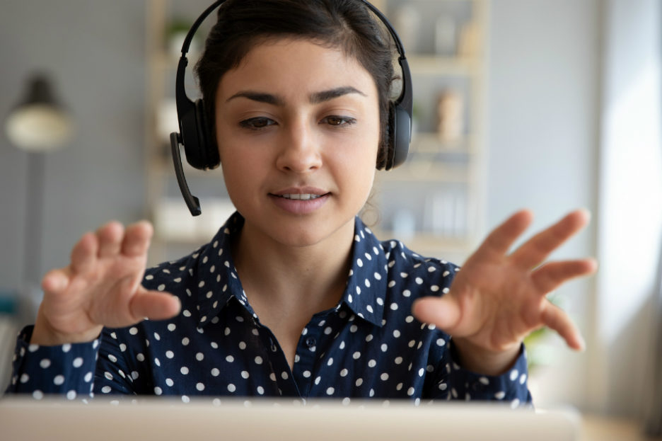 woman with headphones on computer, online counseling
