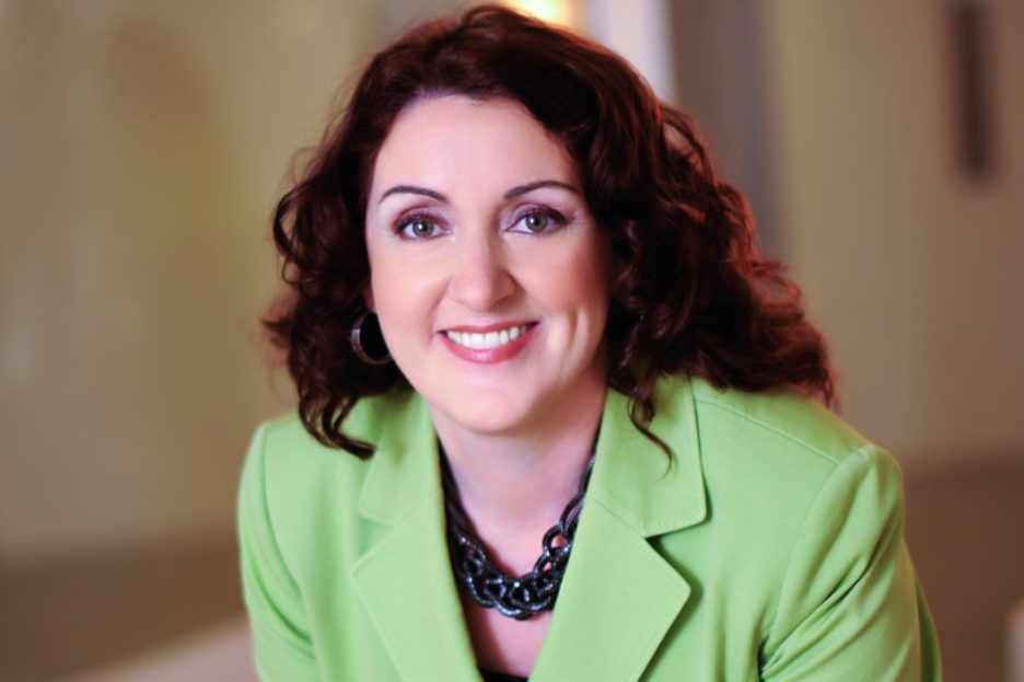 The Chicago School's president, Michele Nealon, Psy.D., smiles for the camera in an official portrait.