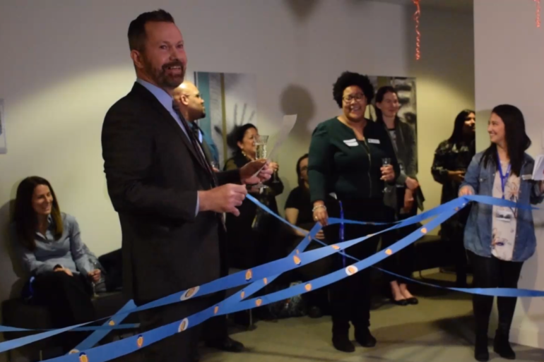 mike russell holding ribbons at interwoven