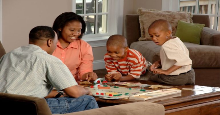 family playing board game at home