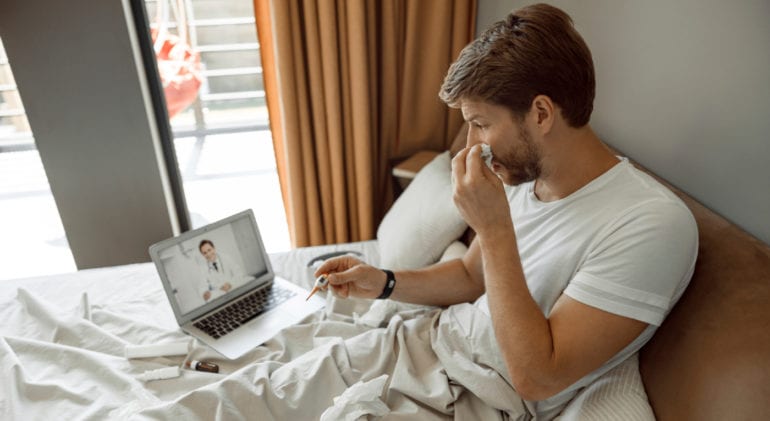 Man in bed with cold