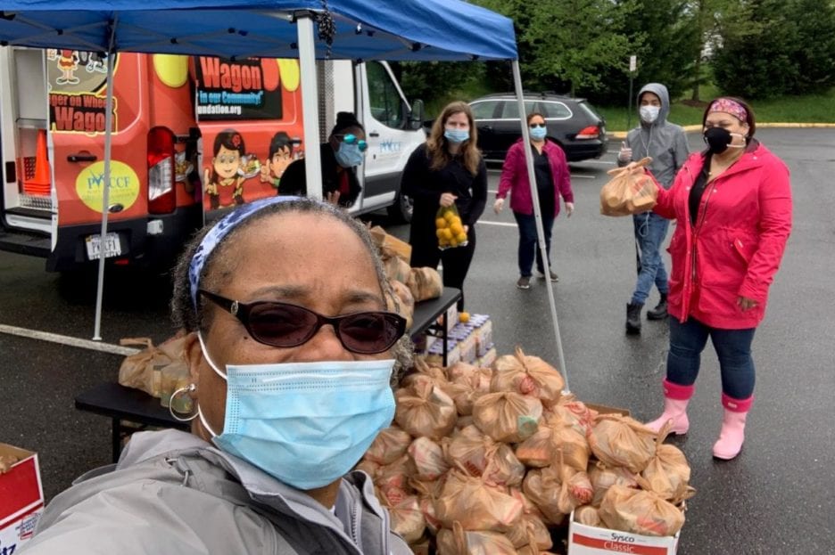 woman wearing sunglasses and a mask at a food drive