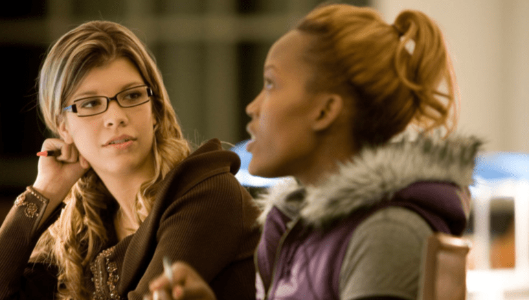 two woman talking in class
