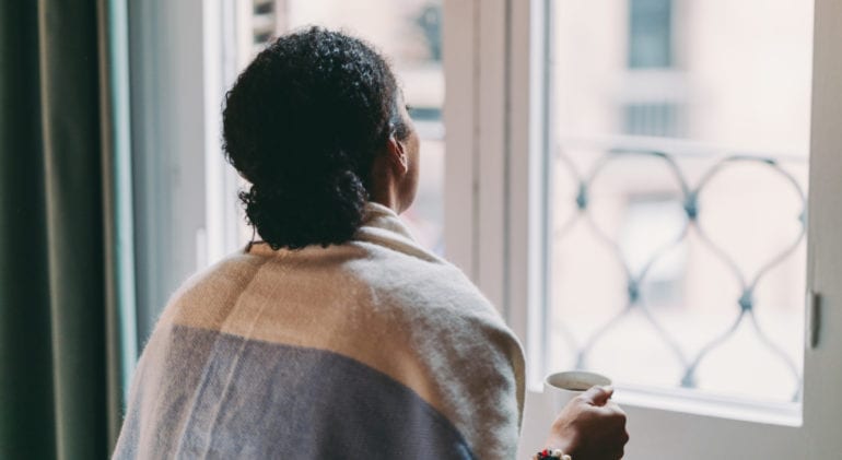 woman looking out window