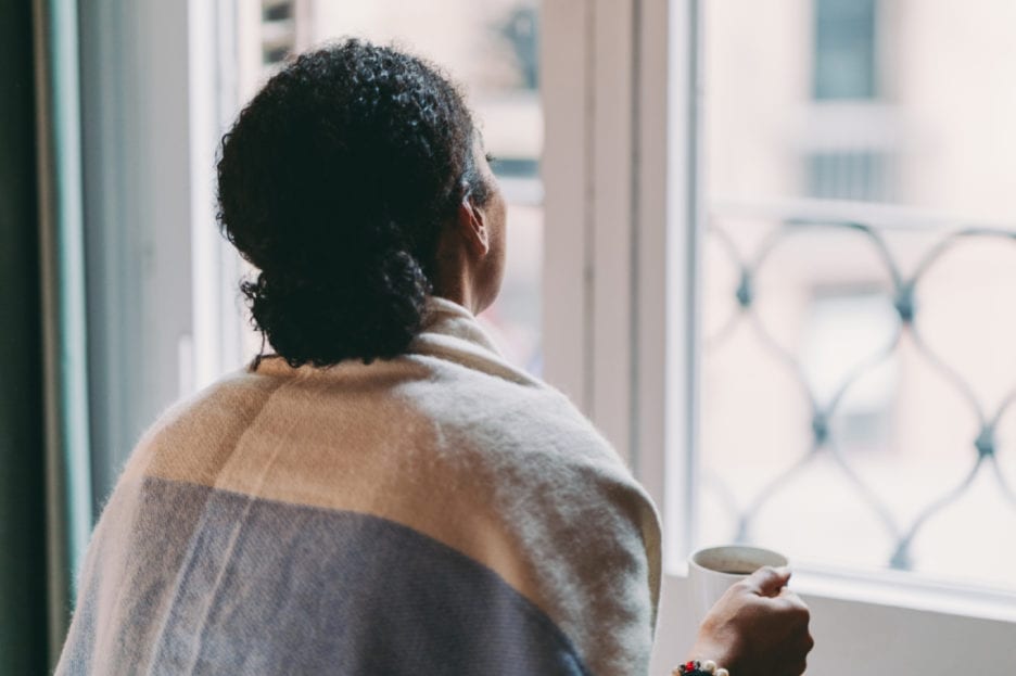 woman looking out window