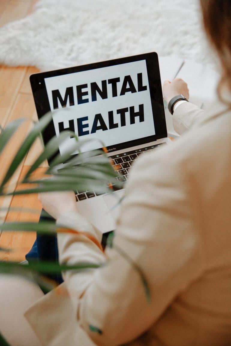 laptop computer with the words Mental Health displayed on it