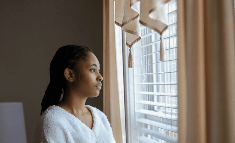 woman looking out the window