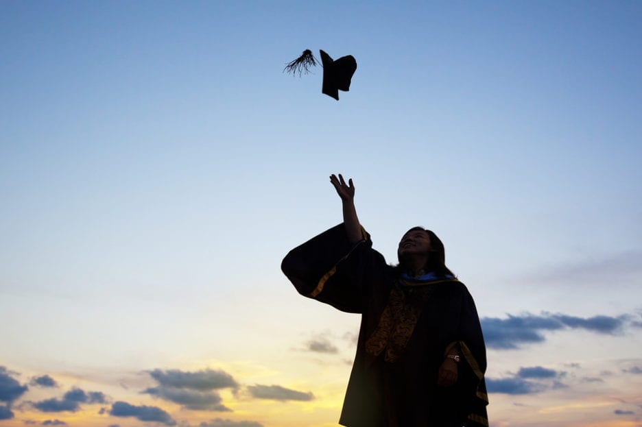 Silhouette Of Young Female Student Celebrating Graduation