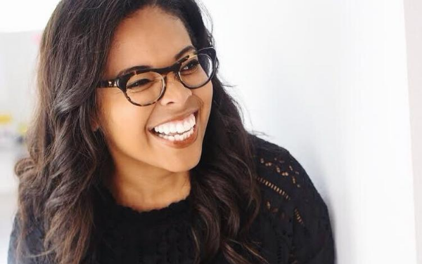 woman with glasses smiling