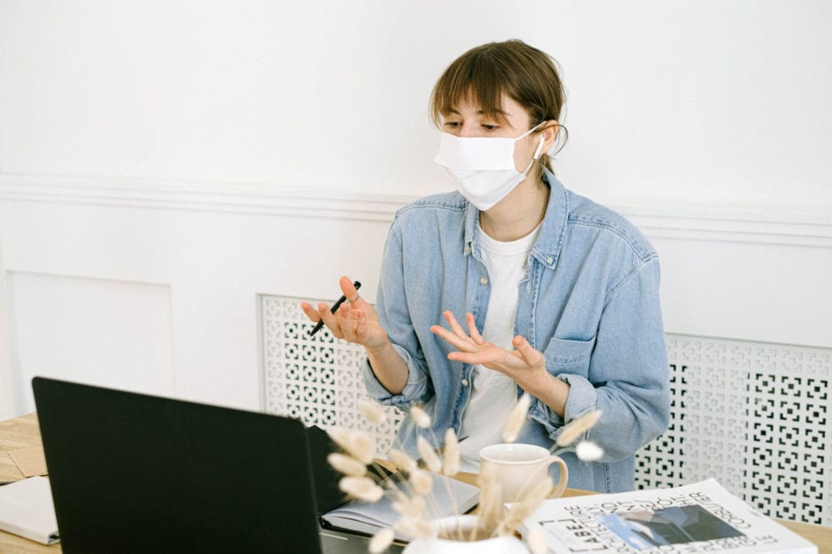 working on computer while wearing a mask