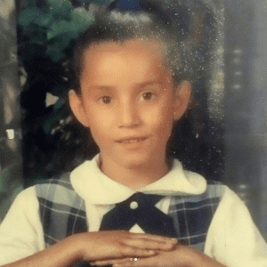 Maritza Flores as a young child in school photo