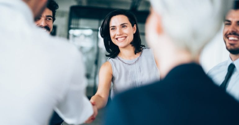 business psychologist pursuing her career and shaking hands in an interview