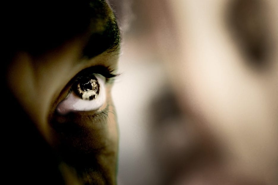 close up of half a face with light across the eye
