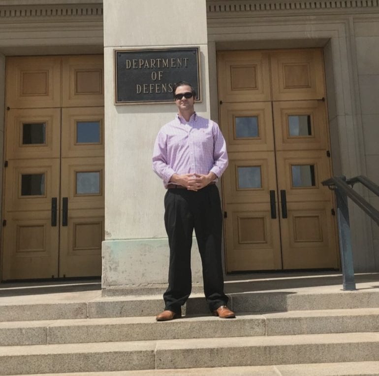 Anthony Edgecomb standing at Dept. of Defense building