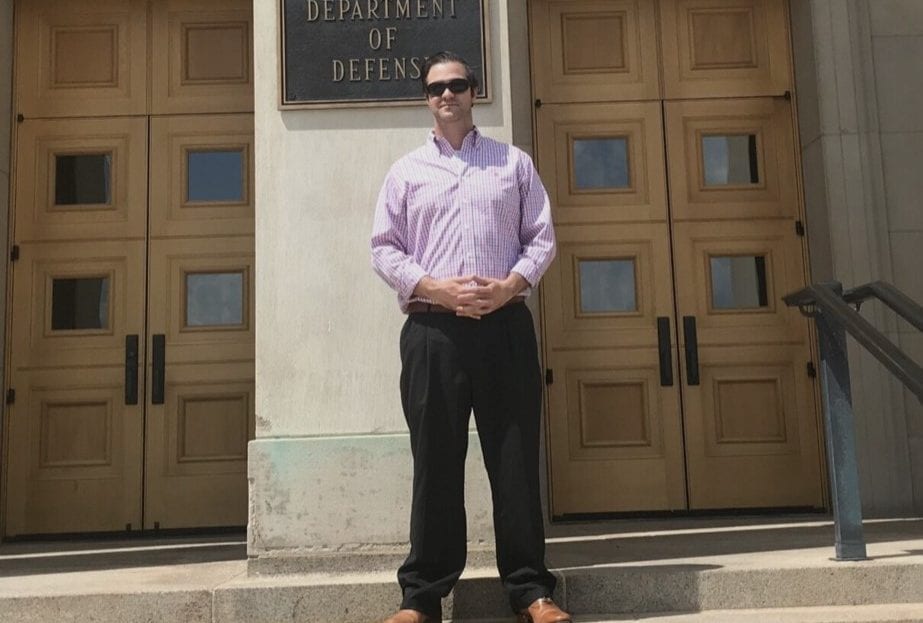 Anthony Edgecomb standing at Dept. of Defense building
