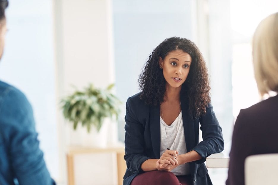 Therapist sitting with a couple in session