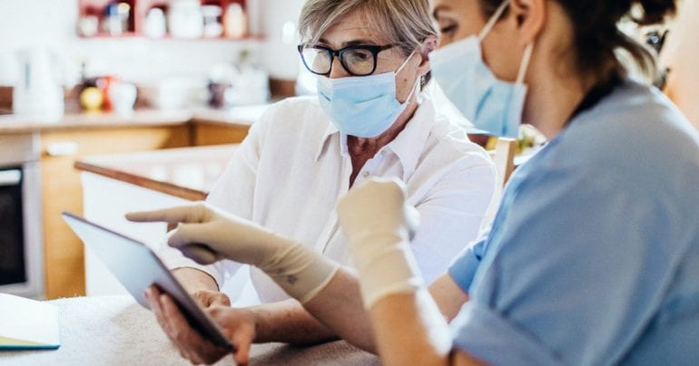 Medical professionals looking at a tablet