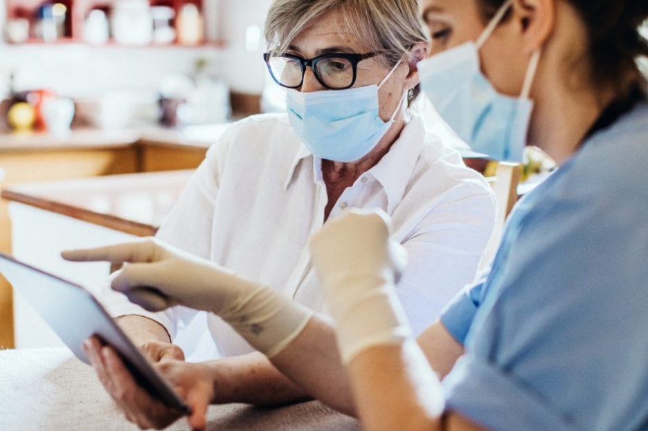 Medical professionals looking at a tablet