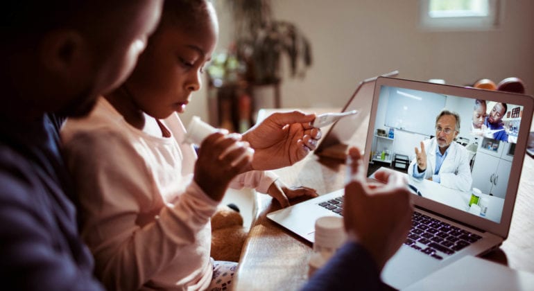 parent and child have a discussion with doctor in a video call