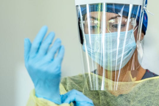 nurse donning ppe