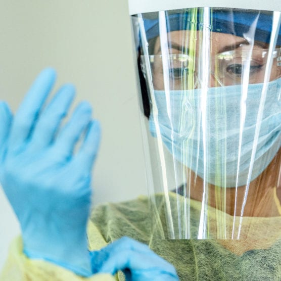 nurse donning ppe