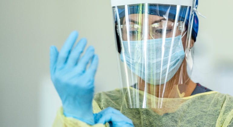 nurse donning ppe