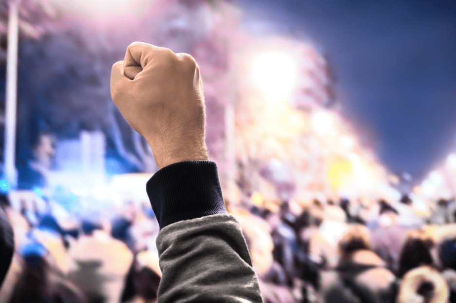 person with fist raised in the air