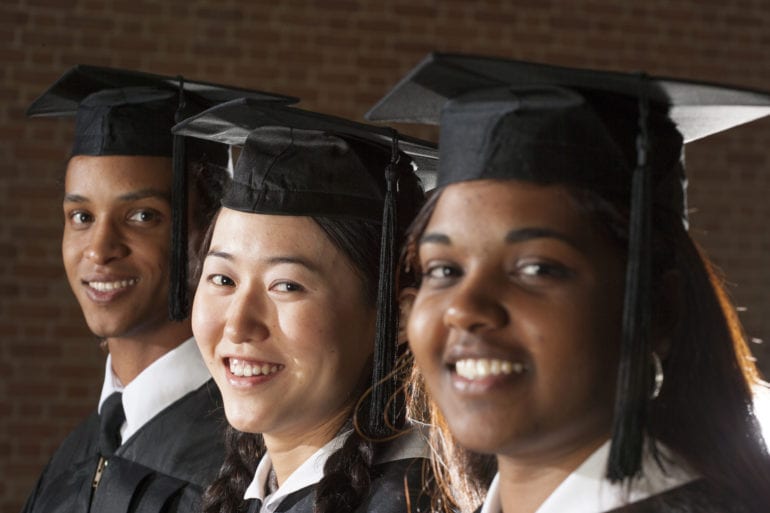 students at graduation in caps and gowns