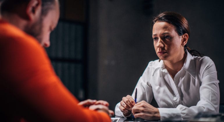 A criminologist uses knowledge from their criminology degree to interact with a criminal.