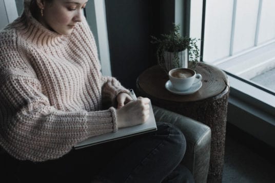 woman writing in journal